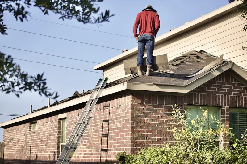 Professional roofer working on a residential roof in Blue Bell Gardens